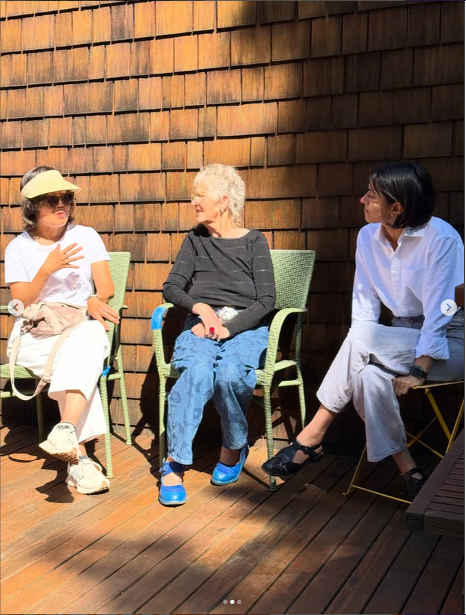 Neighbors discuss topics with Darshini during the garden gathering